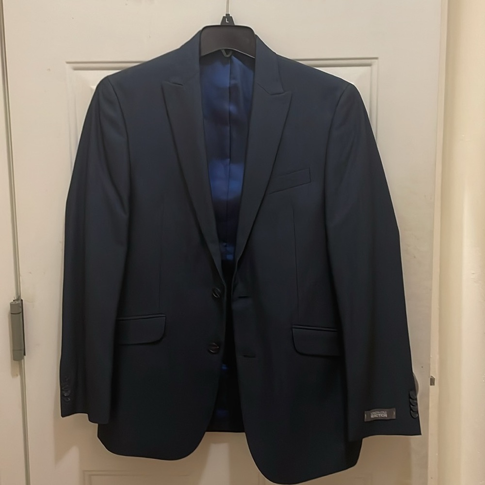 Kenneth Cole ReactionNWT 2-piece Navy Blue suit; 77% polyester 30% rayon.